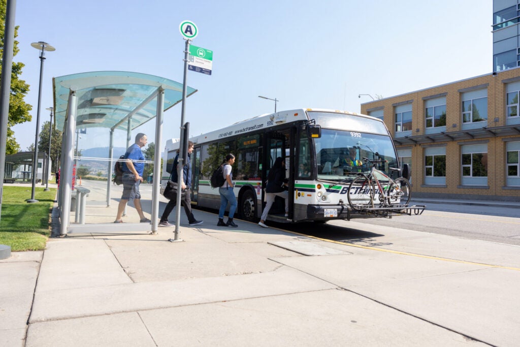 Group of transit users walking on the bus.