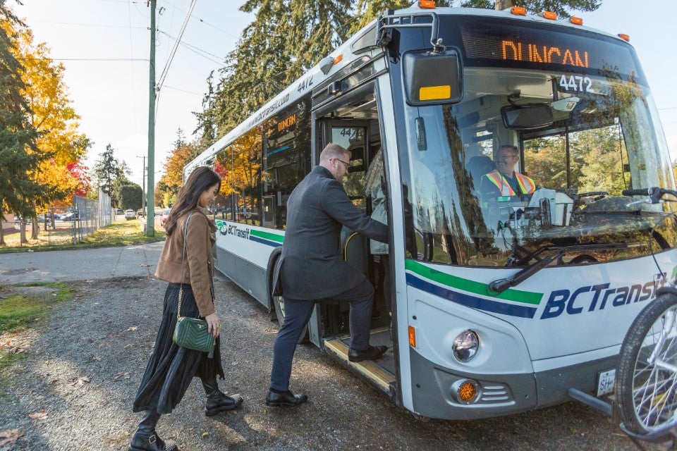 Man and woman boarding a BC Transit bus toward Duncan.