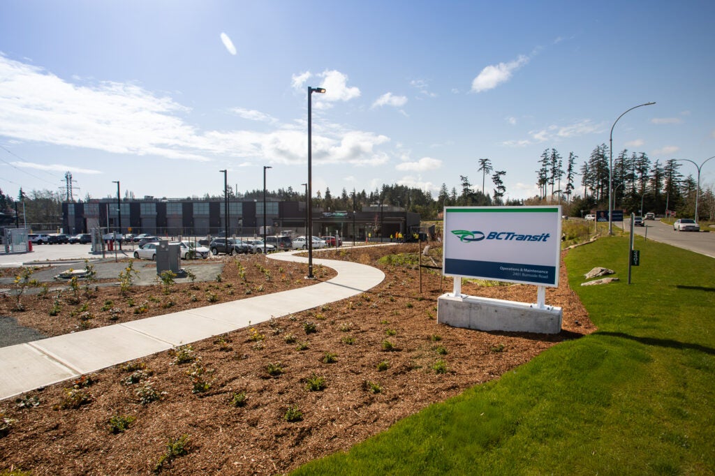 The Victoria handyDART Centre main building and parking lot on a sunny summer day.