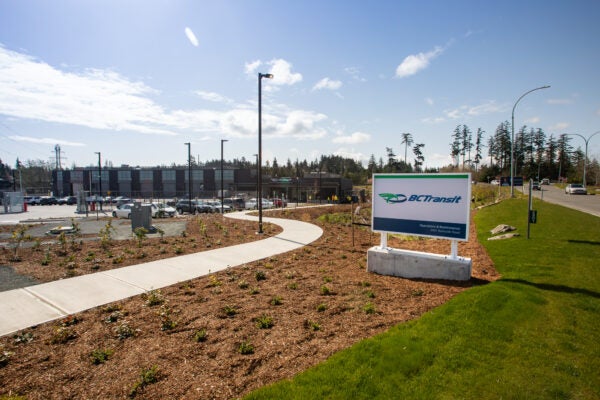 The Victoria handyDART Centre main building and parking lot on a sunny summer day.