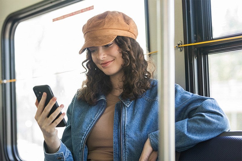 A transit rider looking at her phone