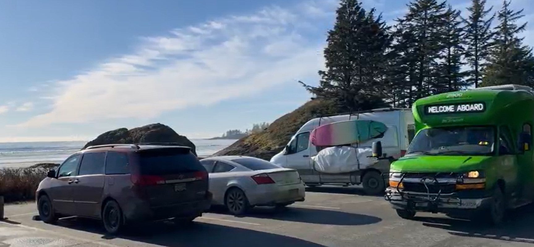 BC Transit bus next to Long Beach and parked cars.