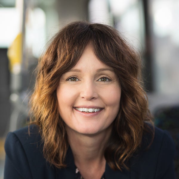 A close up shot of Melissa Zimmerman, Vice President, People and Cultures, sitting in a transit bus.
