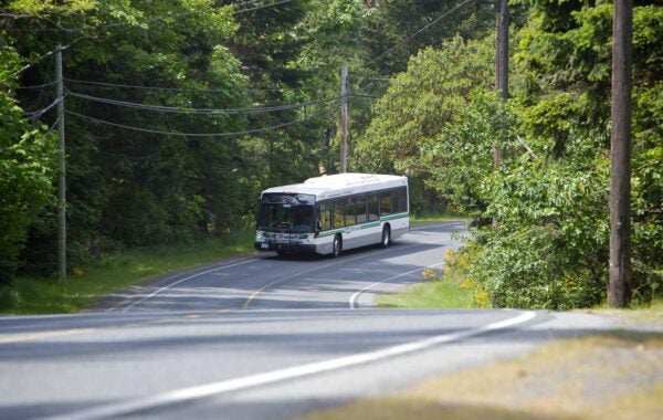 A BC Transit bus on a rural highway.