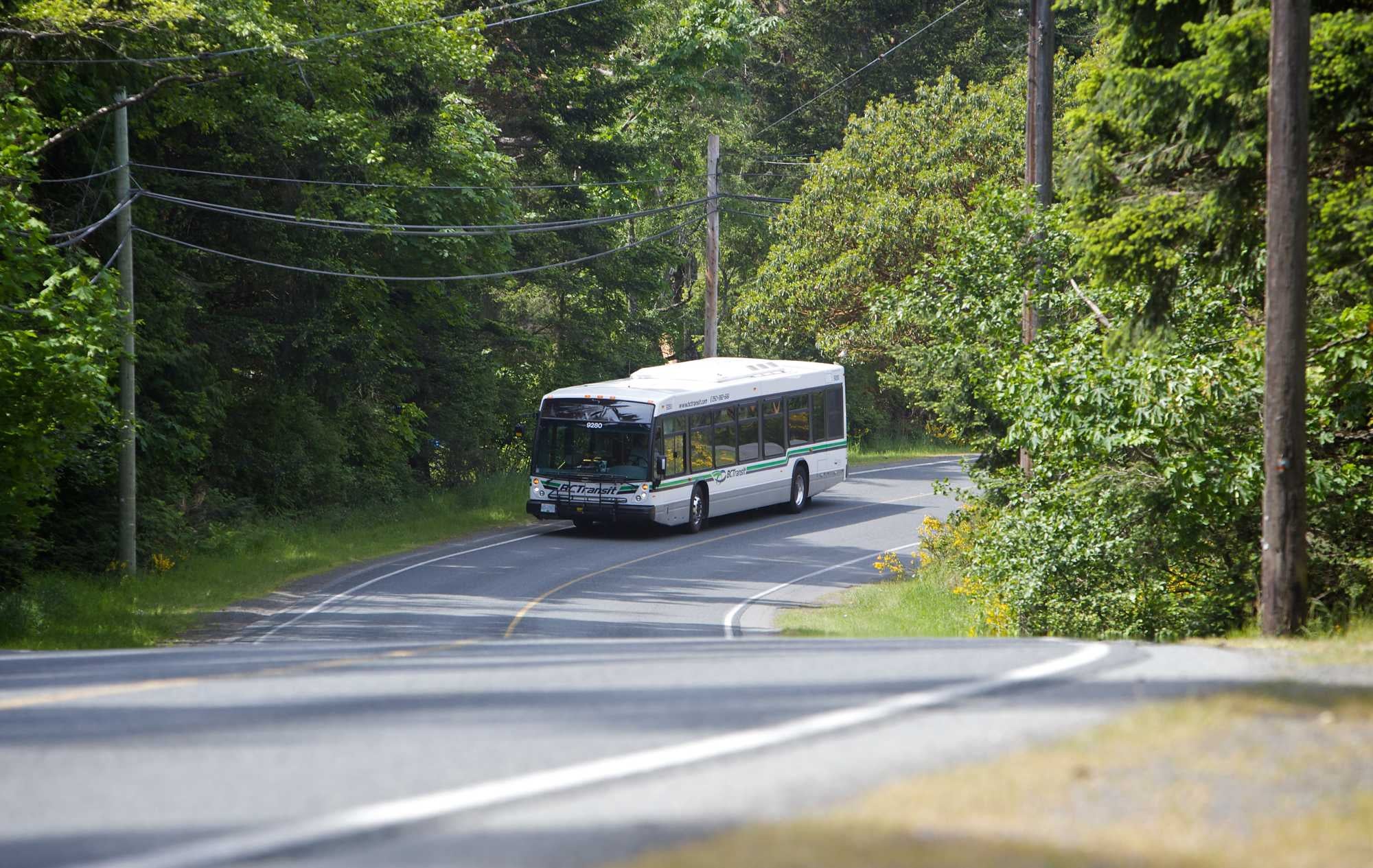A BC Transit bus on a rural highway.